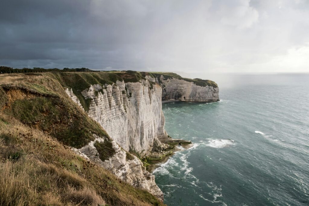 pexels photo 5839286 5839286 Majestic cliffs at Étretat, Normandy, France, under a dramatic cloudy sky.